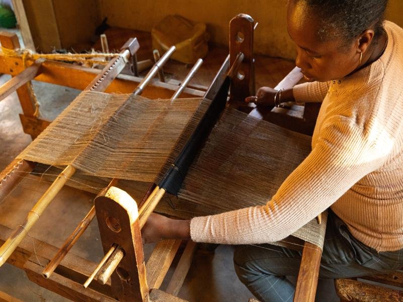They cook the natural cocoons and it is a long process to make the thread by hand, then loom to weave