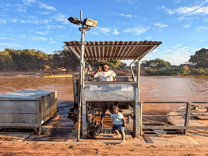 Boy operating the shorter river crossing boat