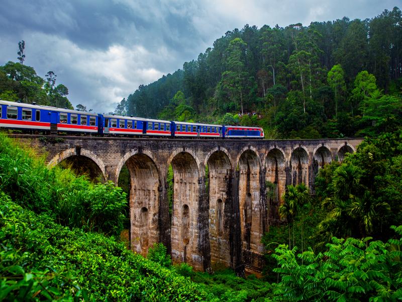 Train on 9 arch bridge