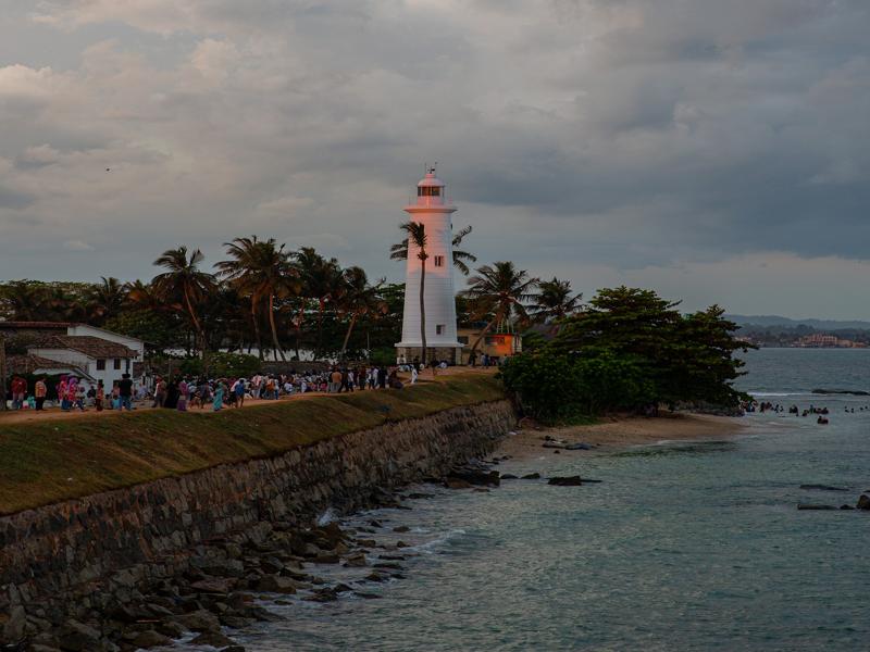 Galle lighthouse and crowds at sunset