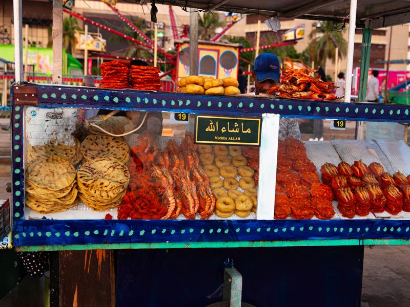 Many vendors with lentil patties with shrimp and crab